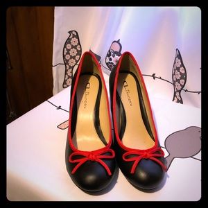 Women’s black high heeled shoes with red piping